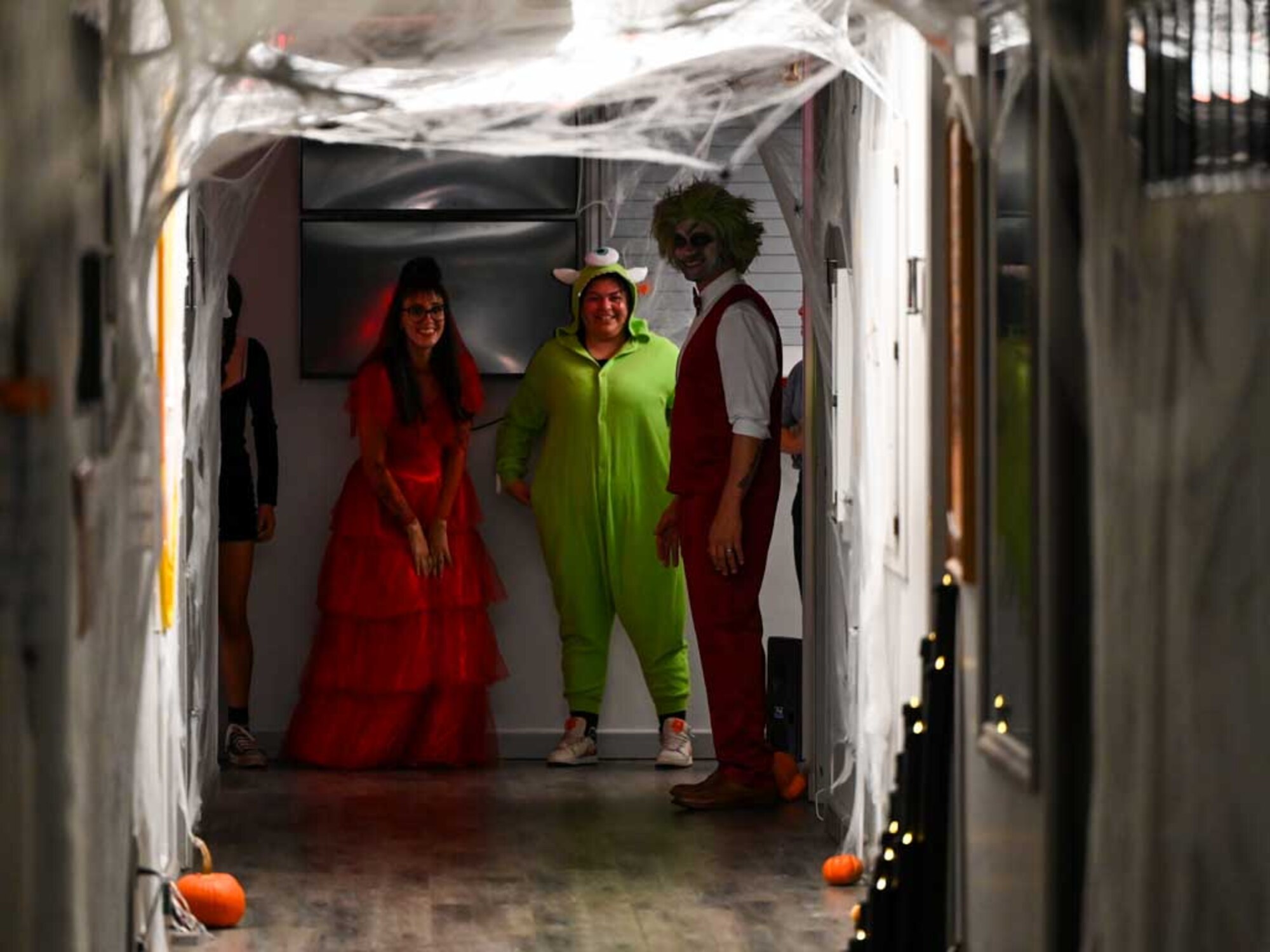 Volunteers in creative costumes welcome visitors to the haunted hallway during the 552nd Air Control Wing’s Boo Bash at Tinker Air Force Base. The spooky setup added excitement and fun for families attending the Halloween-themed event.
(U.S. Air Force photo by Garrett N. Cole)