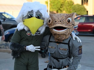 Captain Sentry, the 552nd Air Control Wing mascot, poses with Tink, the Tinker Air Force Base mascot, during the Boo Bash at Tinker AFB. The mascots were a hit with families, adding to the fun and festive Halloween celebration.
(U.S. Air Force photo by Garrett N. Cole)
