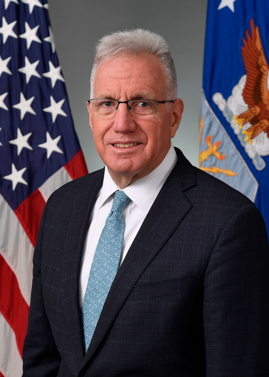 An Air Force civilian stands for a portrait