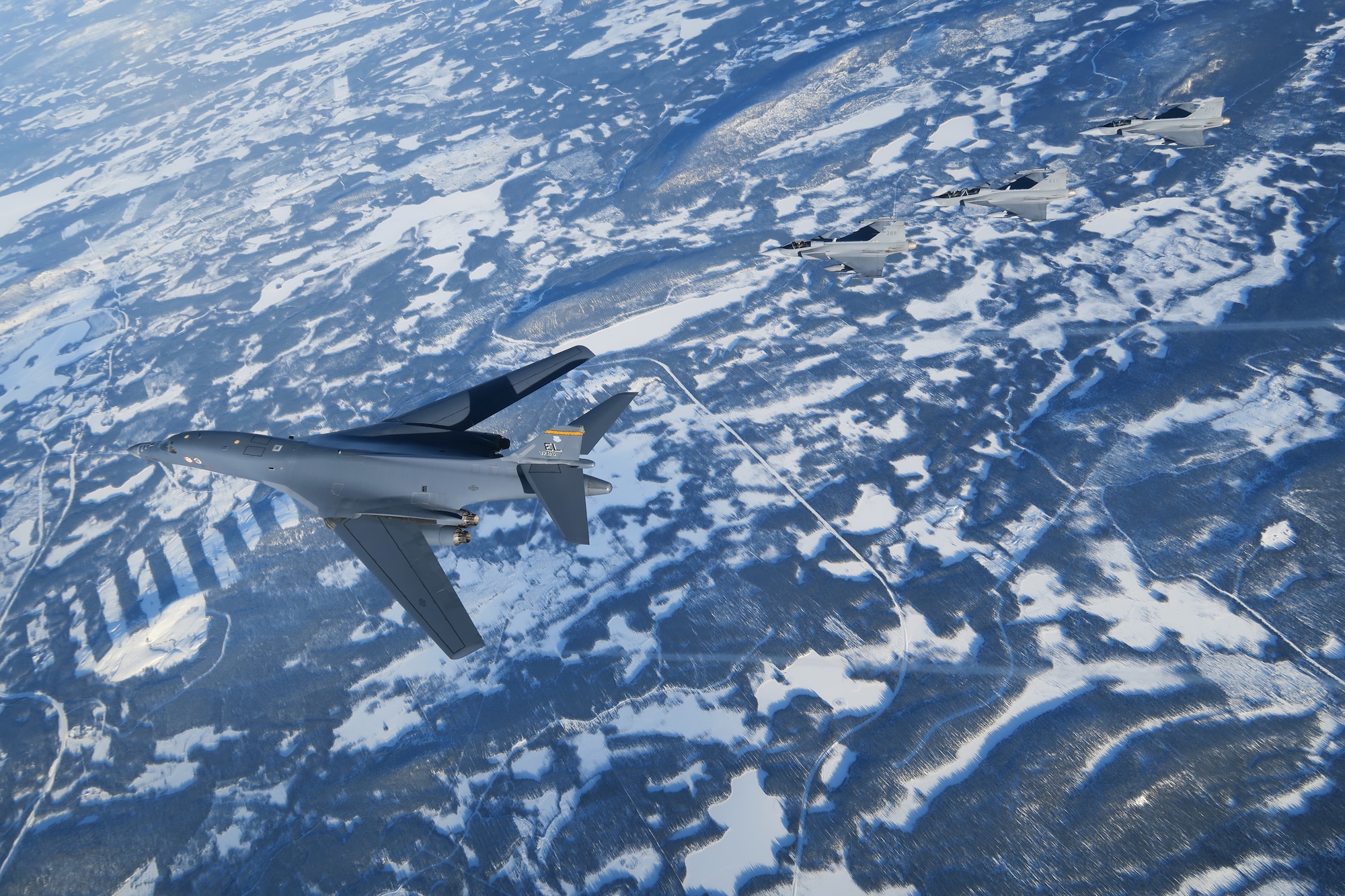 A B-1 flies with JAS 39 Gripens
