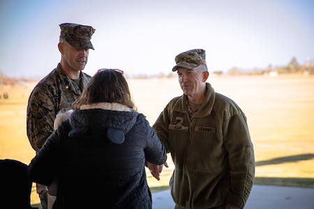 U.S. Army Cyber Center of Excellence Chief of Staff Col. Joel Houk welcomes incoming Marine Detachment Commander Maj. Wesley Nix and his wife after a change of command ceremony at Barton Field on Fort Eisenhower, Ga.