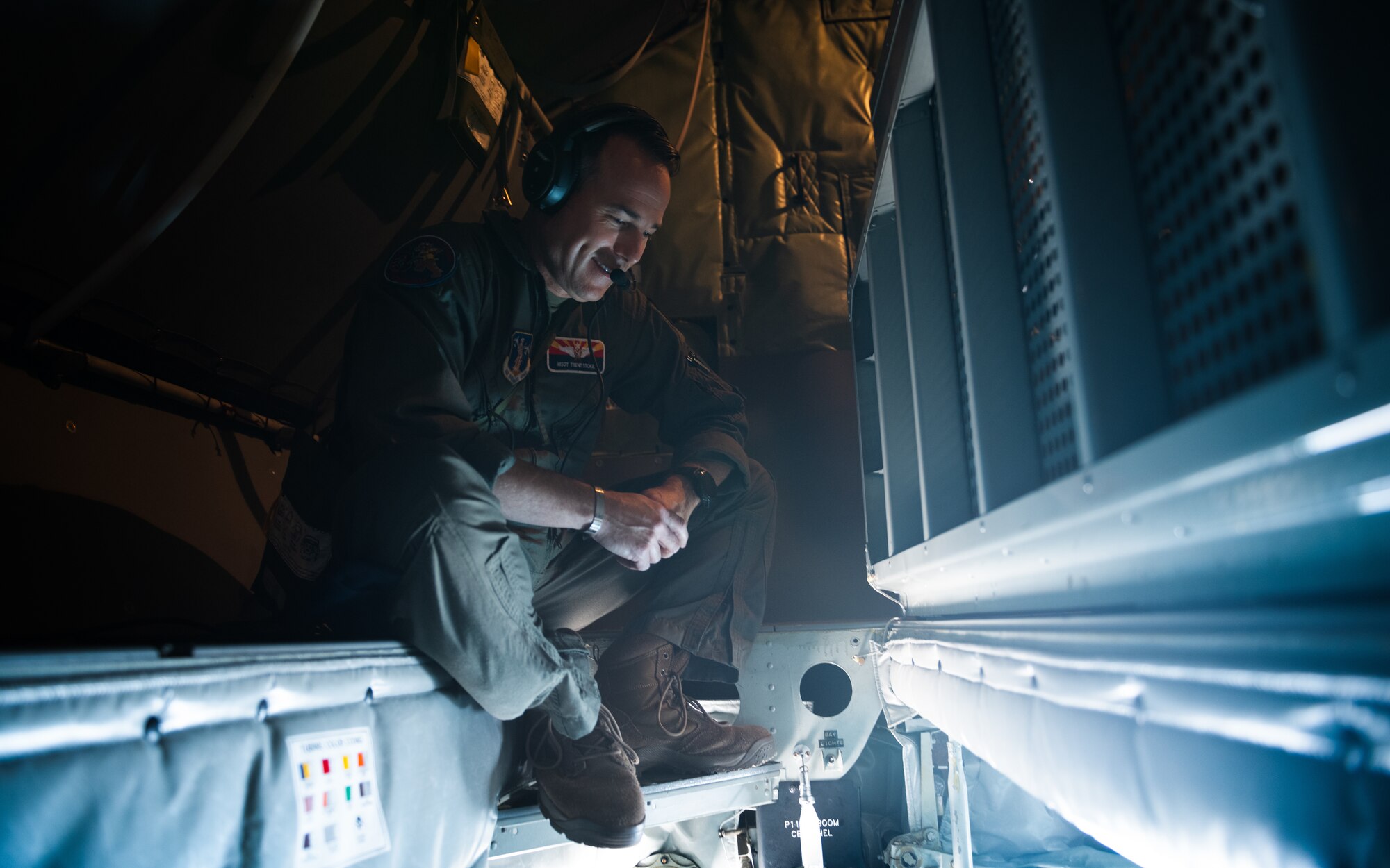 U.S. Air Force MSgt Trent Stokes, 161st Air Refueling Wing boom operator, supervises as honorary commanders view refueling operations from the boom pod of a U.S. Air Force KC-135 Stratotanker.