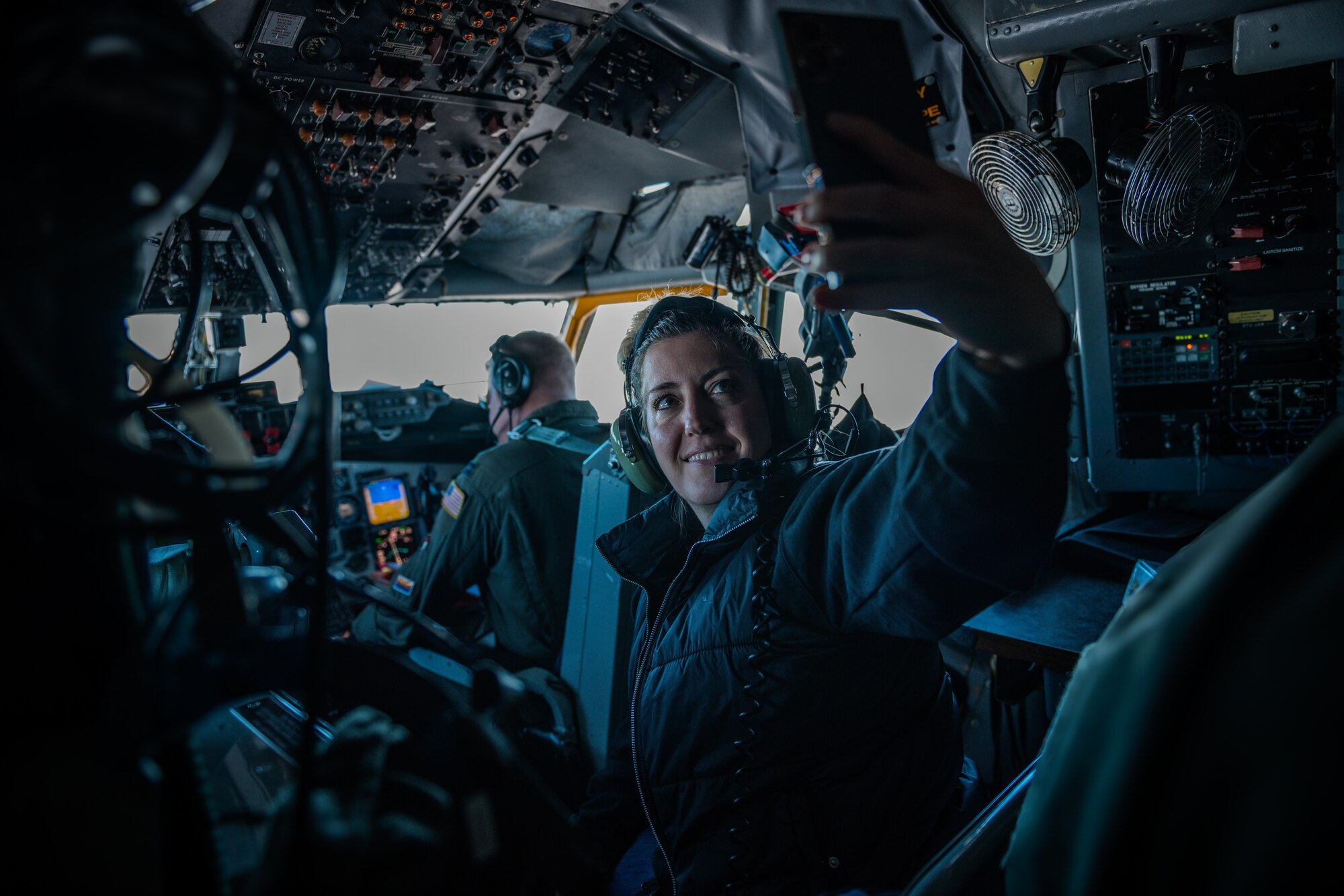 Sarah Krahenbuhl, 56th Operations Group honorary commander, snaps a photo near the cockpit of a U.S. Air Force KC-135 Stratotanker.