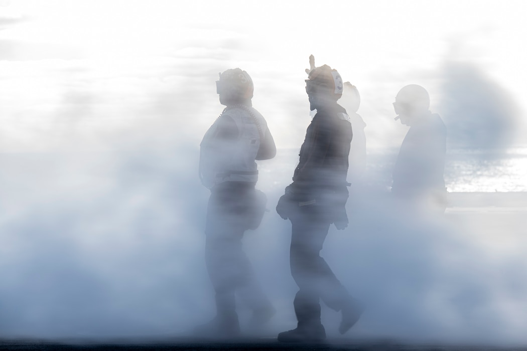 Sailors direct aircraft aboard USS Nimitz (CVN 68) in the Pacific Ocean.