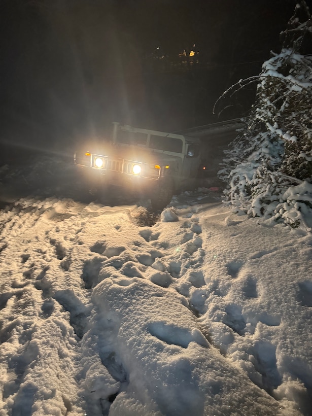 Soldiers with Headquarters and Headquarters Company/Forward Support Company, 201st Engineer Battalion traverse difficult terrain in their HMMWV to support transportation missions in Boyd County.