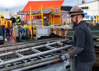 A TRFB team member works at Delta Pier.