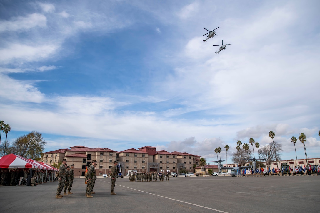 A U.S. Marine Corps UH-1Y Venom, left, and AH-1Z Viper conduct a fly-over during the 15th Marine Expeditionary Unit’s change of command ceremony at Marine Corps Base Camp Pendleton, California, Jan. 16, 2025. During the ceremony, Col. Sean Dynan relinquished command of the 15th MEU to Col. Robb McDonald. (U.S. Marine Corps photo by Sgt. Patrick Katz)