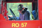 A man looks inside a firetruck.