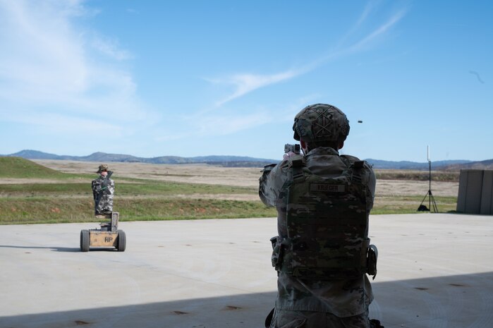 U.S. Air Force 2nd Lt. Nathan Krueger, 9th Security Forces Squadron (SFS) flight commander, fires an M18 pistol at an autonomous robot at Beale Air Force Base, California, Jan. 13, 2025.