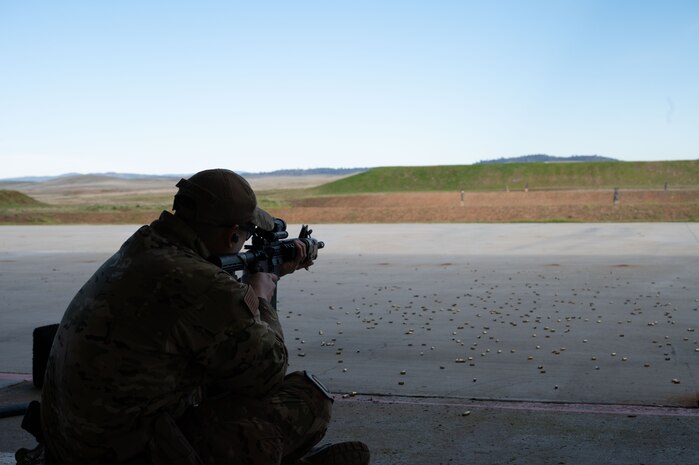U.S. Air Force Tech. Sgt. Dan Deladingco, 9th Security Forces Squadron (SFS) flight sergeant, fires an M4 carbine at artificial intelligence-driven robots at Beale Air Force Base, California, Jan. 13, 2025.