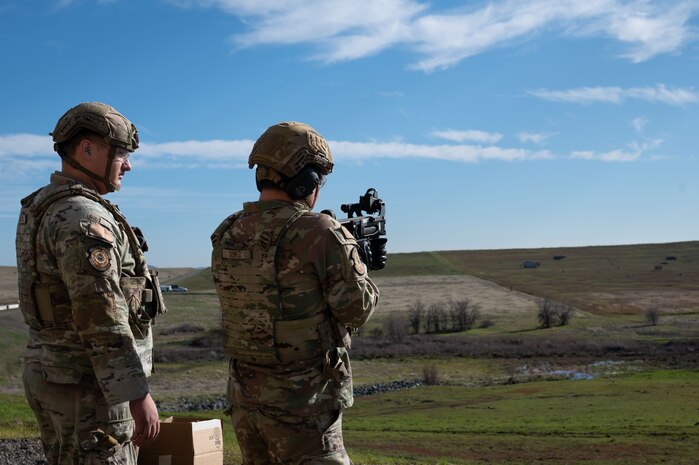U.S. Air Force Airman 1st Class Colin Goyette, left, and Airman 1st Class Victor Gomez, 9th Security Forces Squadron (SFS), installation entry controllers, participate in mobile target training at Beale Air Force Base, California, Jan. 14, 2025.