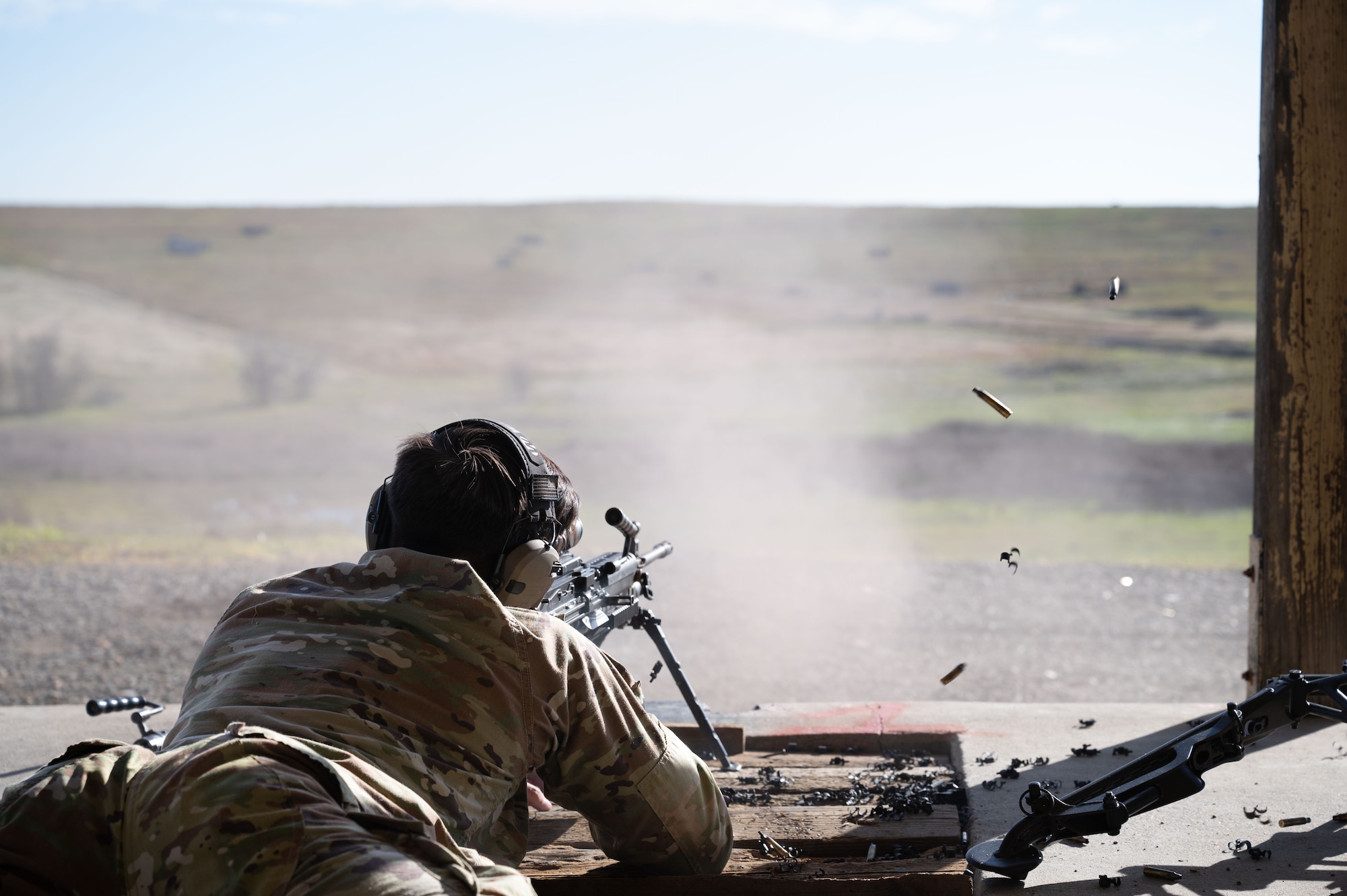U.S. Air Force Tech. Sgt. Michael Ionin, 9th Security Forces Squadron (SFS) combat arms NCO in charge, fires an M249 light machine gun at mobile robot targets at Beale Air Force Base, California, Jan. 14, 2025.