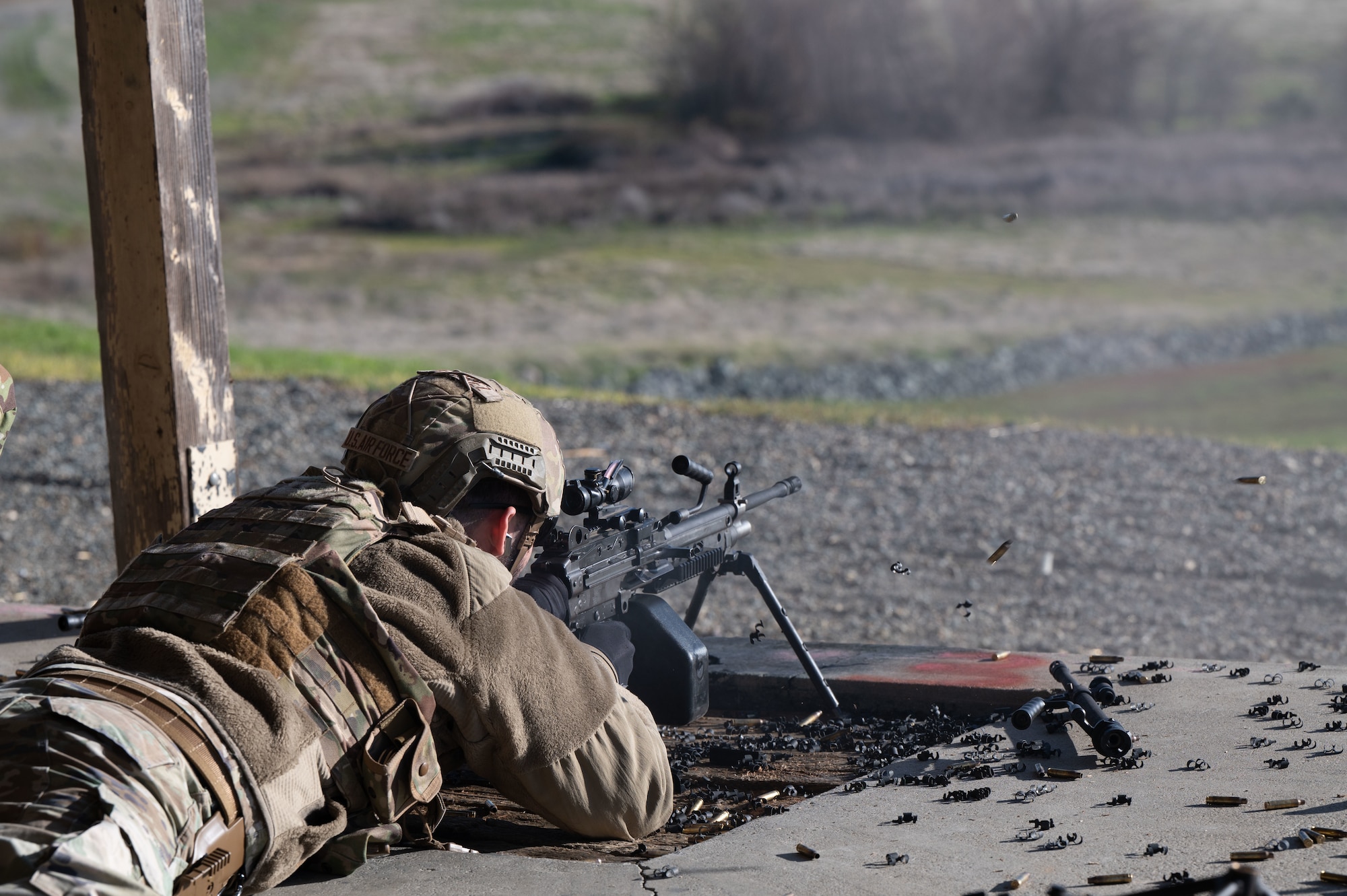 U.S. Air Force Senior Airman Gabriel Menendez, 9th Security Forces Squadron (SFS), installation entry controller, fires an M249 light machine gun at artificial intelligence-driven robots at Beale Air Force Base, California, Jan. 14, 2025.