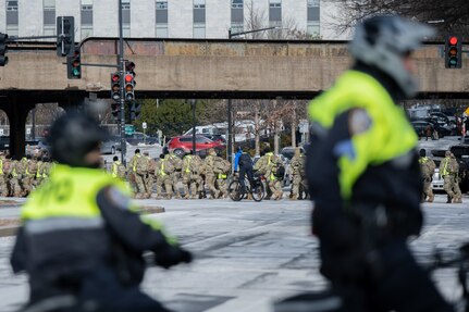 Soldiers and airmen from the Idaho National Guard, assigned to Joint Task Force-District of Columbia (JTF-DC), are escorted by U.S. Capitol Police and New York Police to their assigned crowd control points in Washington, D.C., Jan. 20, 2025. Approximately 8,000 National Guard service members from approximately 40 states and territories comprise JTF-DC to support the 60th Presidential Inauguration, continuing a legacy that began in 1789 when their predecessors escorted George Washington to the first inauguration. At the request of civil authorities, these National Guard service members provide critical support such as crowd management, traffic control points, CBRN response, civil disturbance response and sustainment operations. Their expertise and seamless collaboration with interagency partners help ensure a safe and peaceful transition of power during this historic event.