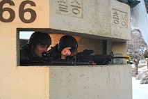 Senior Airman Anthony Newton, left, and SrA Christian Jackson, 8th CPTS financial comptroller management journeymen, post at their defensive fighting position during Beverly Pack 25-1 at Kunsan Air Base, Republic of Korea, Jan. 13, 2025.