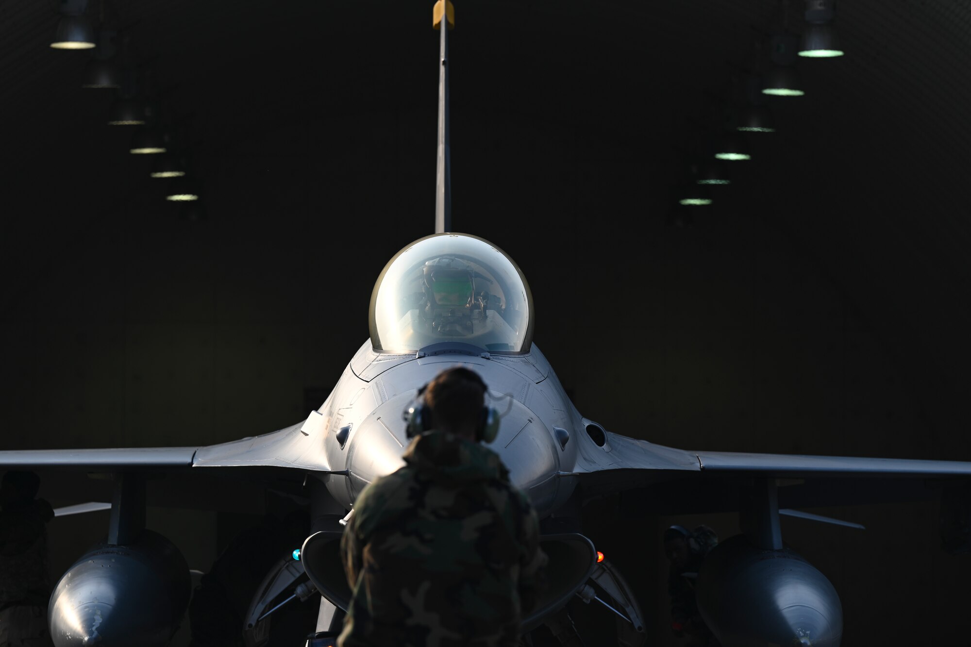 Airman 1st Class Layne Veldhuizen, 35th Fighter Generation Squadron assistant dedicated crew chief, prepares to taxi U.S. Air Force Capt. Tom Marron, 35th Fighter Squadron F-16 Fighting Falcon pilot, at Gwangju Air Base, Republic of Korea, Jan. 14, 2025.