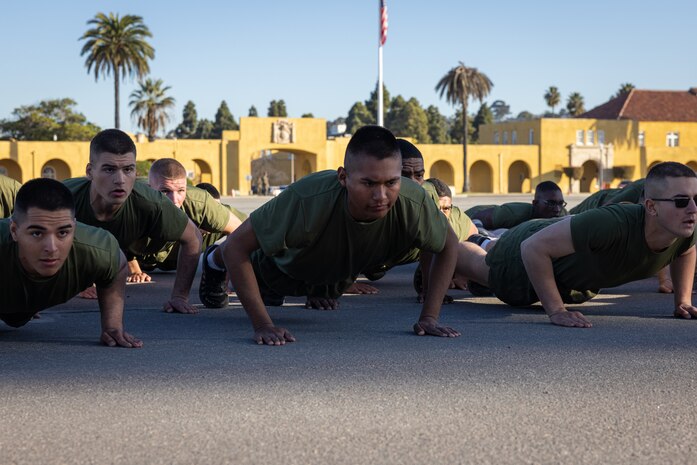 The new U.S. Marines of Lima Company, 3rd Recruit Training Battalion, execute dynamic warm-ups prior to the company motivational run at Marine Corps Recruit Depot San Diego, California, Jan. 16, 2025. The company motivational run is a three-mile cadence run conducted around the Depot and is the last physical training event the Marines will conduct before they graduate from MCRD San Diego. The event is also the first-time friends and families will see their newly transformed Marines. Most ready when our nation is least ready, we train Marines to defeat the challengers, obstacles, and potential adversaries that hinder our nation’s progress and threaten our peace and security. (U.S. Marine Corps photo by Lance Cpl. Jacob Hutchinson)