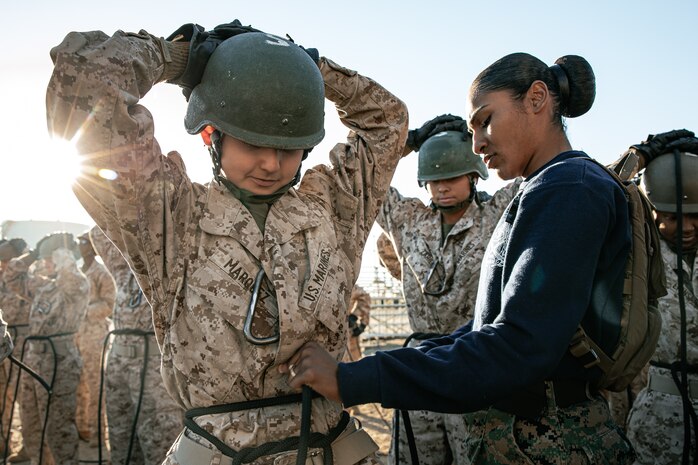 U.S. Marine Corps Drill Instructor, Sgt. Myrka Sorianoromero with Lima Company, 3rd Recruit Training Battalion, adjusts a Marines’ harness prior to the rappel tower at Marine Corps Recruit Depot San Diego, California, Jan. 10, 2025. The rappel tower provides opportunities for the new Marines to gain confidence in themselves and their gear and is one of the last training events Marines will conduct while at MCRD San Diego. Most ready when our nation is least ready, we train Marines to defeat the challengers, obstacles, and potential adversaries that hinder our nation’s progress and threaten our peace and security. (U.S. Marine Corps photo by Cpl. Sarah M. Grawcock)
