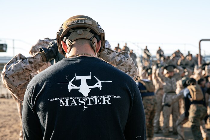 A U.S. Marine Corps helicopter rope suspension techniques master, with Support Battalion, Recruit Training Regiment, adjusts a Marine’s harness, with Lima Company, 3rd Recruit Training Battalion, prior to the rappel tower at Marine Corps Recruit Depot San Diego, California, Jan. 10, 2025. The rappel tower provides opportunities for the new Marines to gain confidence in themselves and their gear and is one of the last training events Marines will conduct while at MCRD San Diego. Most ready when our nation is least ready, we train Marines to defeat the challengers, obstacles, and potential adversaries that hinder our nation’s progress and threaten our peace and security. (U.S. Marine Corps photo by Cpl. Sarah M. Grawcock)