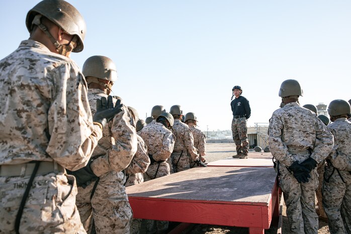 A U.S. Marine Corps Helicopter Rope Suspension Techniques Master and Tower Chief, Staff Sgt. Isaac Castillo with Support Battalion, Recruit Training Regiment, gives instructions to Marines with Lima Company, 3rd Recruit Training Battalion, prior to the rappel tower at Marine Corps Recruit Depot San Diego, California, Jan. 10, 2025. The rappel tower provides opportunities for the new Marines to gain confidence in themselves and their gear and is one of the last training events Marines will conduct while at MCRD San Diego. Most ready when our nation is least ready, we train Marines to defeat the challengers, obstacles, and potential adversaries that hinder our nation’s progress and threaten our peace and security. (U.S. Marine Corps photo by Cpl. Sarah M. Grawcock)