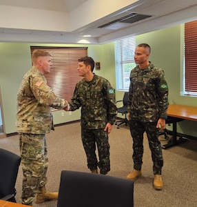 LTC Johnson of WRAIR-West greets the visiting collaborators from the Brazilian Army Research Institute of Physical Fitness (IPCFEx). From left to right: LTC Johnson (WRAIR-West), MAJ Bandeira (IPCFEx), and MAJ Loyola (IPCFEx). (Courtesy Photo)