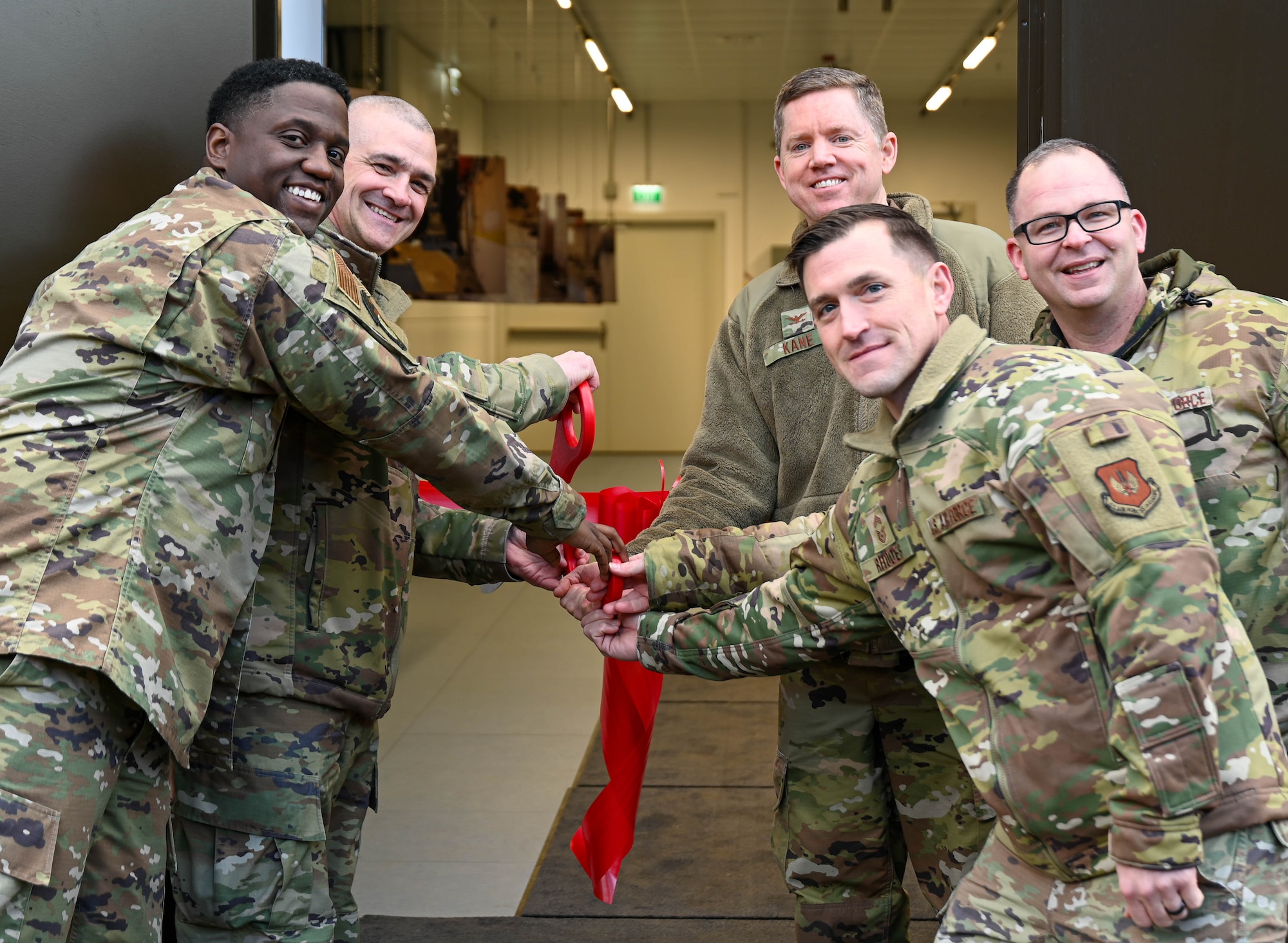 Leadership pose for a picture before cutting the ribbon to reopen a renovated data center.