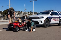 U.S. Marine Corps Lance Cpl. Bruno, the Marine Corps Recruit Depot San Diego and Western Recruiting Region mascot, interacts with members of the Criminal Investigation Division, Headquarters and Service Battalion, during a staged traffic stop, at Marine Corps Recruit Depot San Diego, California, Dec. 10, 2024. The mascot’s job is to boost morale, participate in outreach work, and attend events and ceremonies. (U.S. Marine Corps photo by Lance Cpl. Jacob B. Hutchinson)