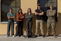 U.S. Marine Corps Lance Cpl. Bruno, the Marine Corps Recruit Depot San Diego and Western Recruiting Region mascot, poses for a photo with members of the Criminal Investigation Division, Headquarters and Service Battalion, at Marine Corps Recruit Depot San Diego, California, Dec. 10, 2024. The mascot’s job is to boost morale, participate in outreach work, and attend events and ceremonies. (U.S. Marine Corps photo by Lance Cpl. Jacob B. Hutchinson)