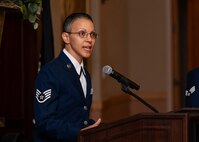 Airman speaking into microphone at event.