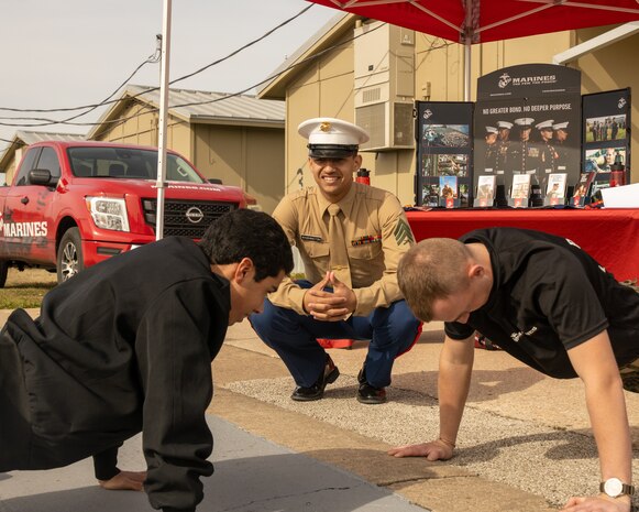 Stony Point High School students perform push-ups in front of U.S. Marines with Recruiting Sub-Station Round Rock, Recruiting Station Austin during a school visit at Stony Point High School in Round Rock, Texas, Jan. 14, 2025. During this visit, the Marines shared their journey and conducted a uniform inspection for Stony Point High School Naval Junior Reserve Officer Training Corps cadets. (U.S. Marine Corps photo by Cpl. Jose D. Cruz)