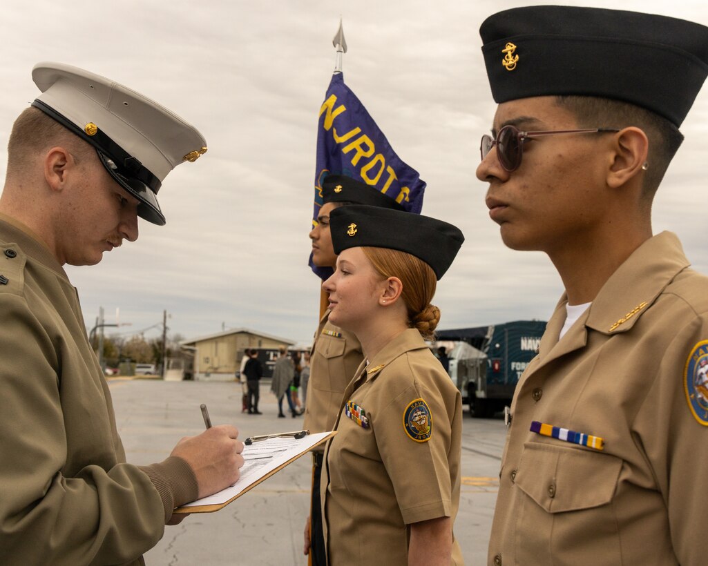 U.S. Marine Corps Sgt. James P. Mack, a canvassing recruiter with Recruiting Sub-Station Round Rock, Recruiting Station Austin inspects a Stony Point High School Naval Junior Reserve Officer Training Corps cadet during a high school visit at Stony Point High School in Round Rock, Texas, Jan. 14, 2025. During this visit, the Marines shared information about the Marine Corps and conducted an uniform inspection the Stony Point High School NJROTC cadets. (U.S. Marine Corps photo by Cpl. Jose D. Cruz)