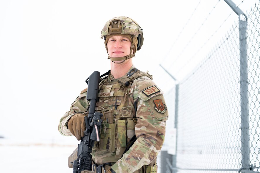 Airman 1st Class Sean Spoerre, 891 Missile Security Forces Squadron defender, poses in front of a Missile Alert Facility at Minot Air Force Base, North Dakota, Dec. 12, 2024. Defenders from the 91st Missile Wing are tasked with ensuring the nation's strategic deterrence mission remains uncompromised. (U.S. Air Force photo by Airman 1st Class Luis Gomez)