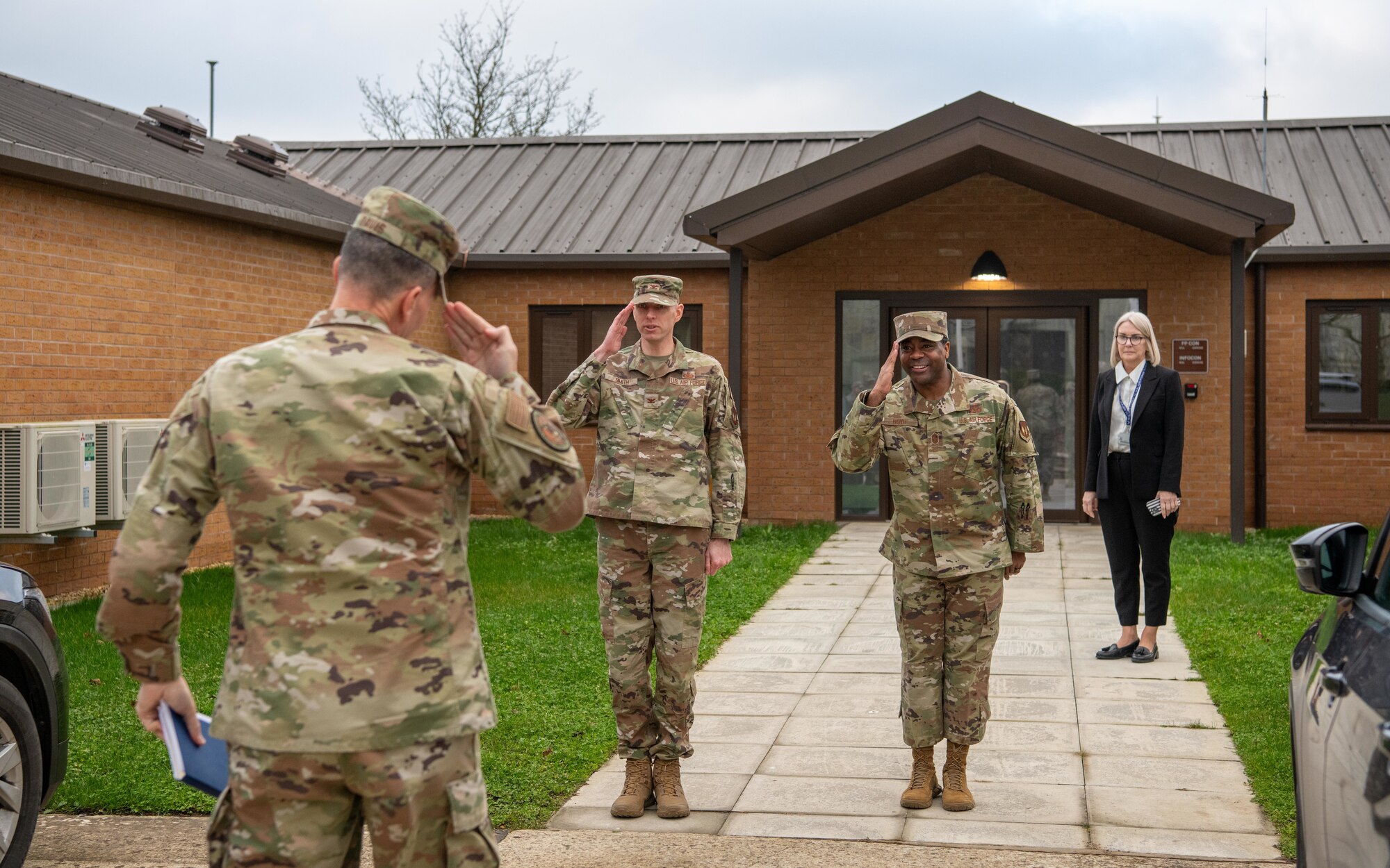 Base leadership perform a salute