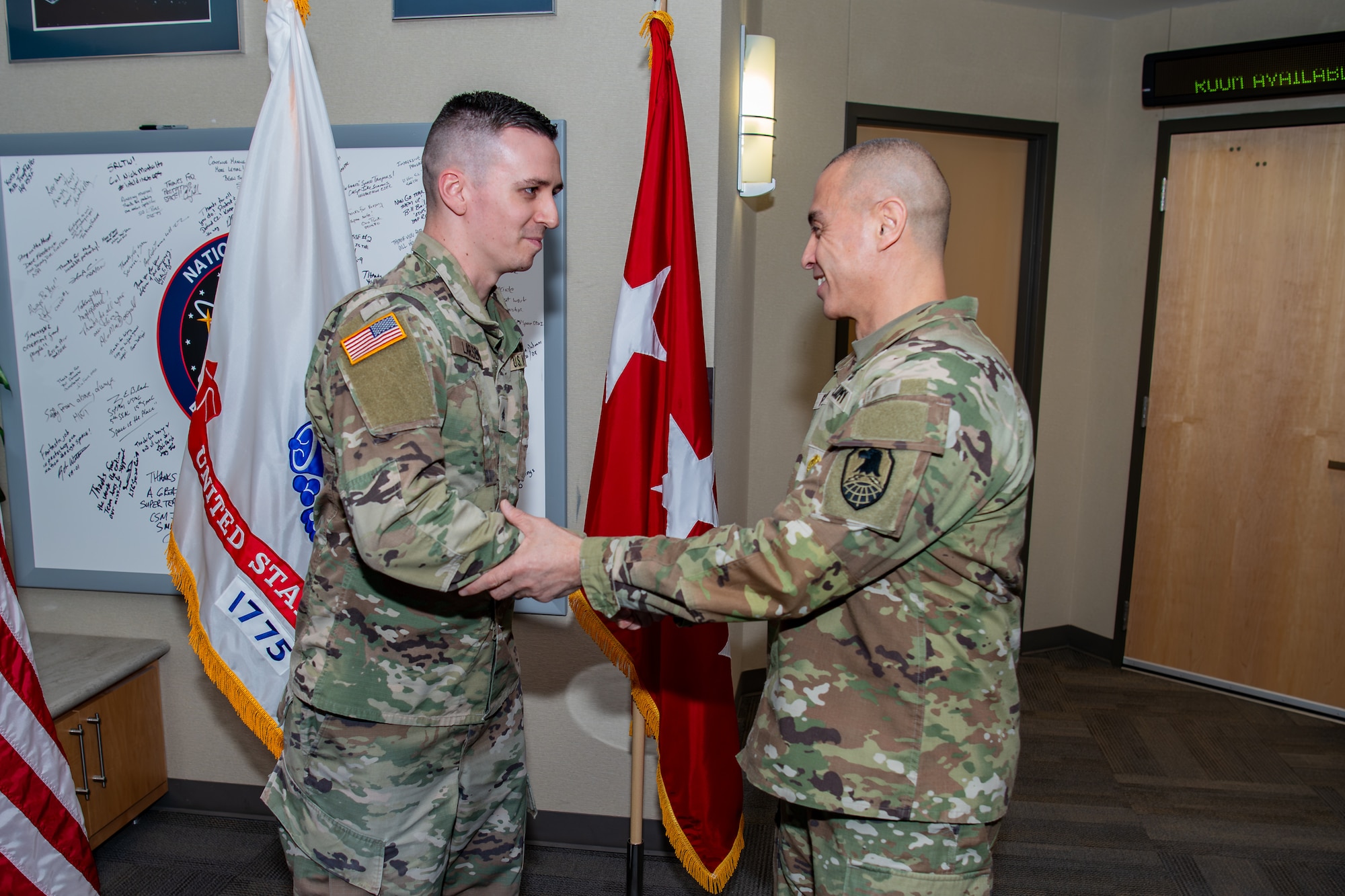 two military members shaking hands