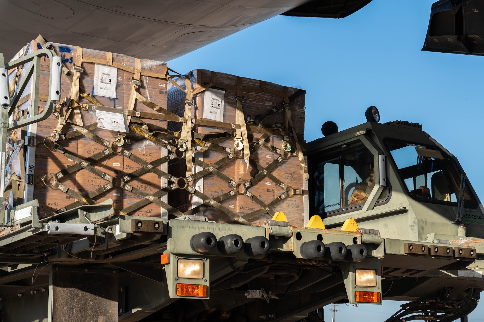 Humanitarian cargo is loaded onto a C-5M Super Galaxy from the 68th Airlift Squadron, Joint-Base San Antonio-Lackland, Texas, at Dyess Air Force Base, Texas, Jan. 16, 2025. The 7th Logistics Readiness Squadron air transportation function routinely participates in humanitarian aid missions through the Denton Program, supporting countries in need worldwide. (U.S. Air Force photo by Senior Airman Alondra Cristobal Hernandez)