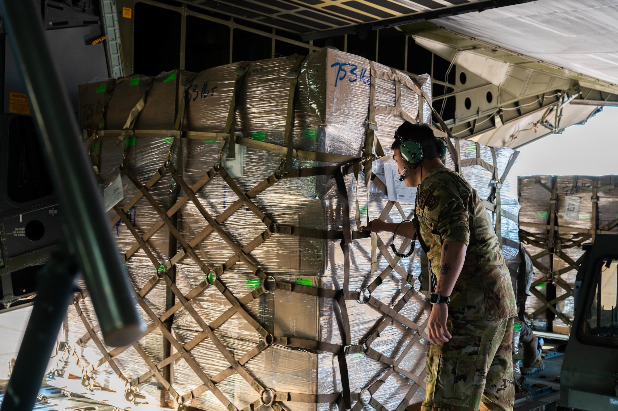 U.S. Air Force Senior Airman Sean Dickerson, 68th Airlift Squadron loadmaster, loads cargo onto a C-5M Super Galaxy from the 68th AS, Joint Base San Antonio-Lackland, Texas, at Dyess Air Force Base, Texas, Jan. 16, 2025. The 7th Logistics Readiness Squadron air transportation function transported 35,730 pounds of rice to Honduras and El Salvador for humanitarian aid. (U.S. Air Force photo by Senior Airman Alondra Cristobal Hernandez)