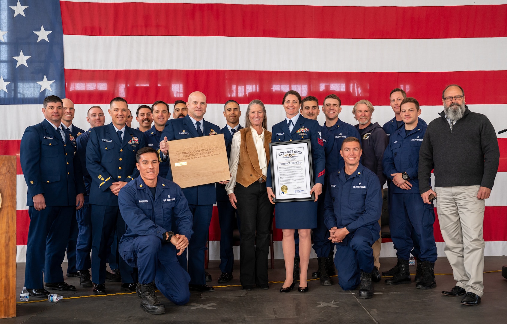 Petty Officer 1st Class Kirsten Allen, a Regional Dive Locker West (MSRT-W) diver, poses with her dive locker after winning the Coastie of the Year award at Coast Guard Sector San Diego, Jan. 22, 2025.