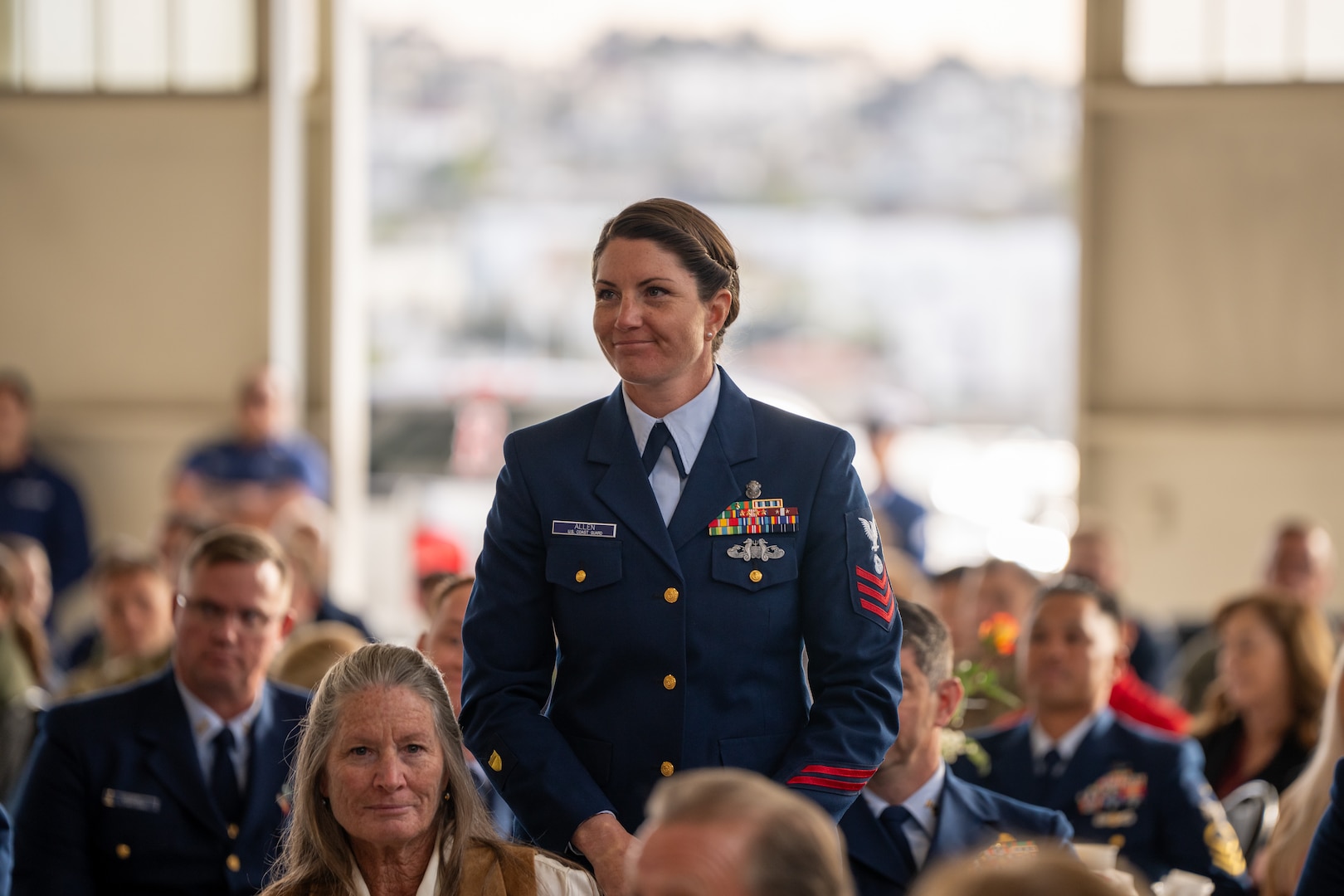 Petty Officer 1st Class Kirsten Allen, a Regional Dive Locker West (MSRT-W) diver, stands in the audience at the inaugural Coastie of the Year awards ceremony at Coast Guard Sector San Diego, Jan. 22, 2025..