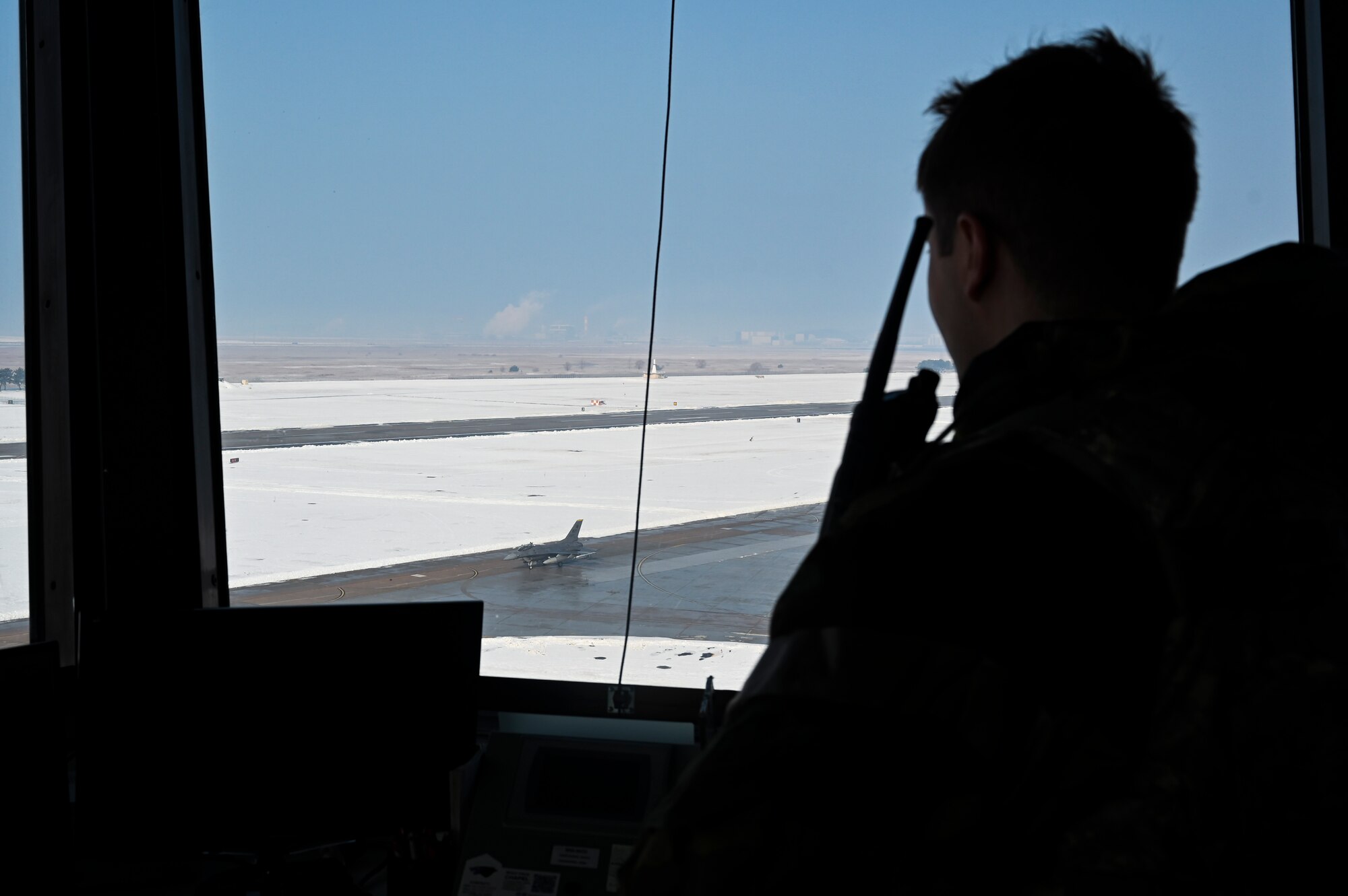 U.S. Air Force Staff Sgt. Christian Darr, 8th Operations Support Squadron watch tower supervisor, oversees an F-16 Fighting Falcon aircraft taxiing on the runway during Beverly Pack 25-1.