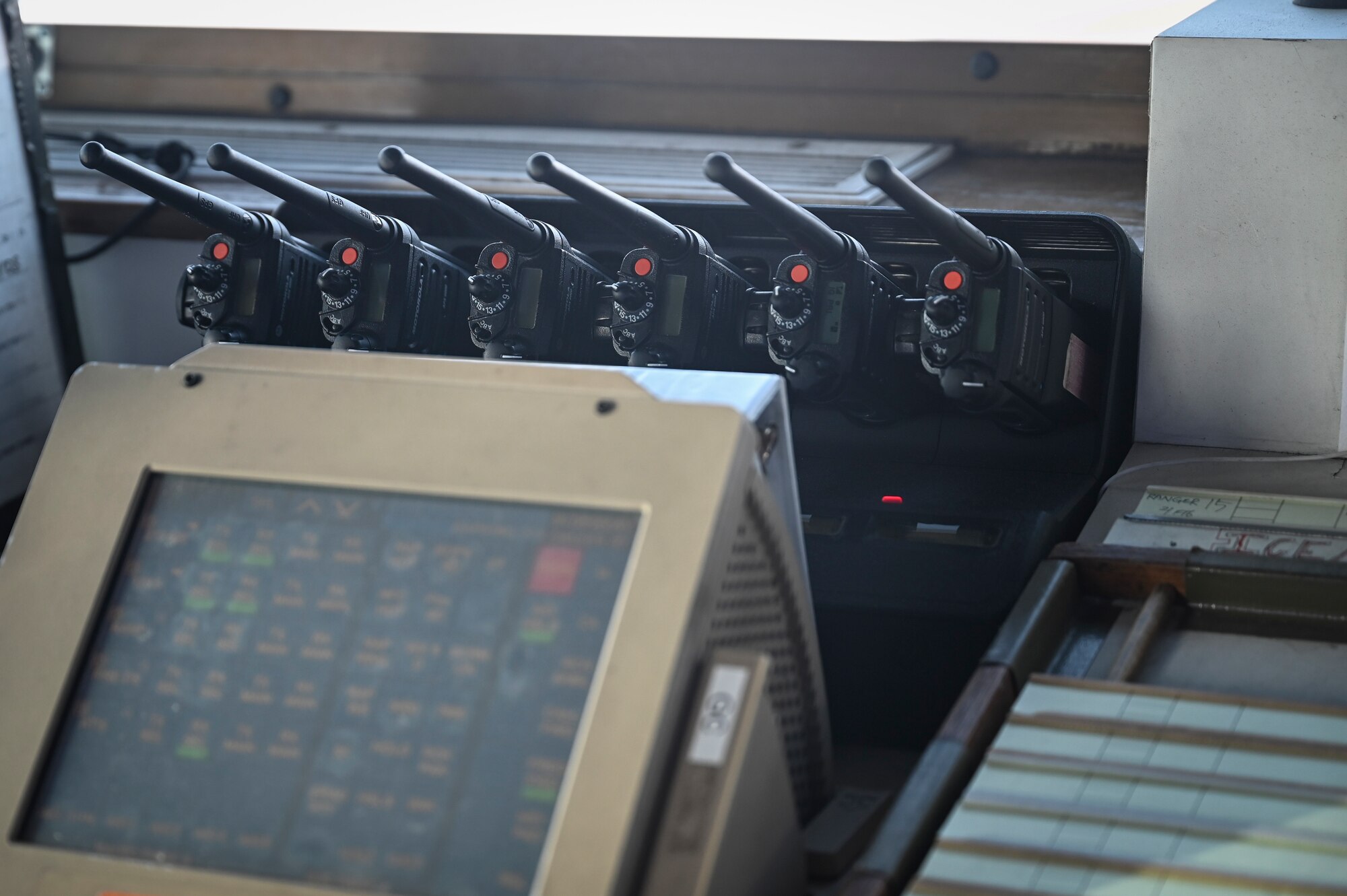 A set of radios is displayed on a table in the air traffic control tower during Beverly Pack 25-1.