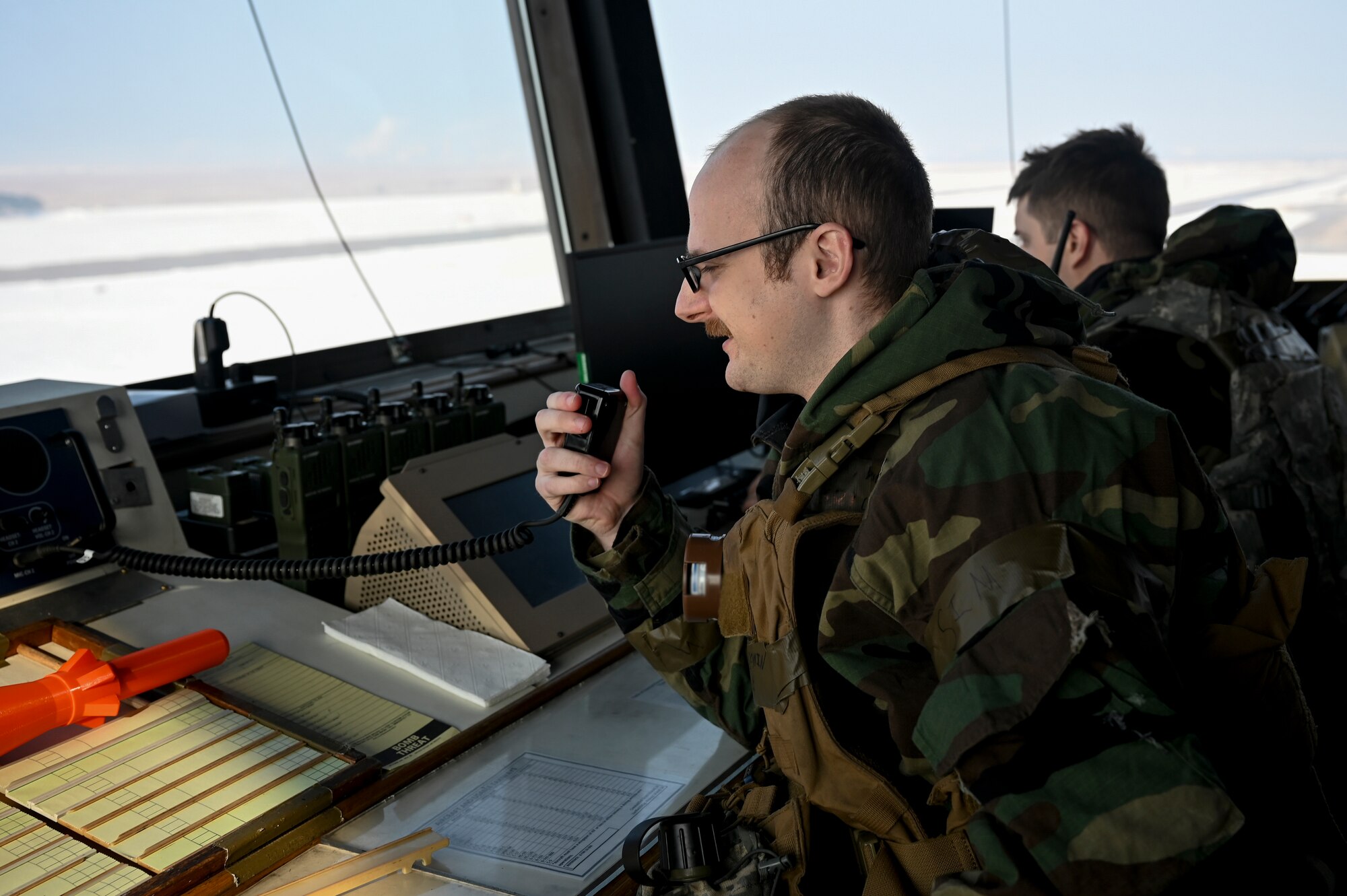 U.S. Air Force Staff Sgt. Benjamin Sites, 8th Operations Support Squadron air traffic control tower trainer, communicates with aircraft over the radio during Beverly Pack 25-1.