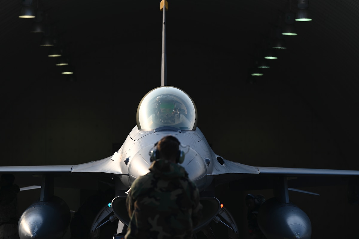Airman 1st Class Layne Veldhuizen, 35th Fighter Generation Squadron assistant dedicated crew chief, prepares to taxi U.S. Air Force Capt. Tom Marron, 35th Fighter Squadron F-16 Fighting Falcon pilot, at Gwangju Air Base, Republic of Korea, Jan. 14, 2025.