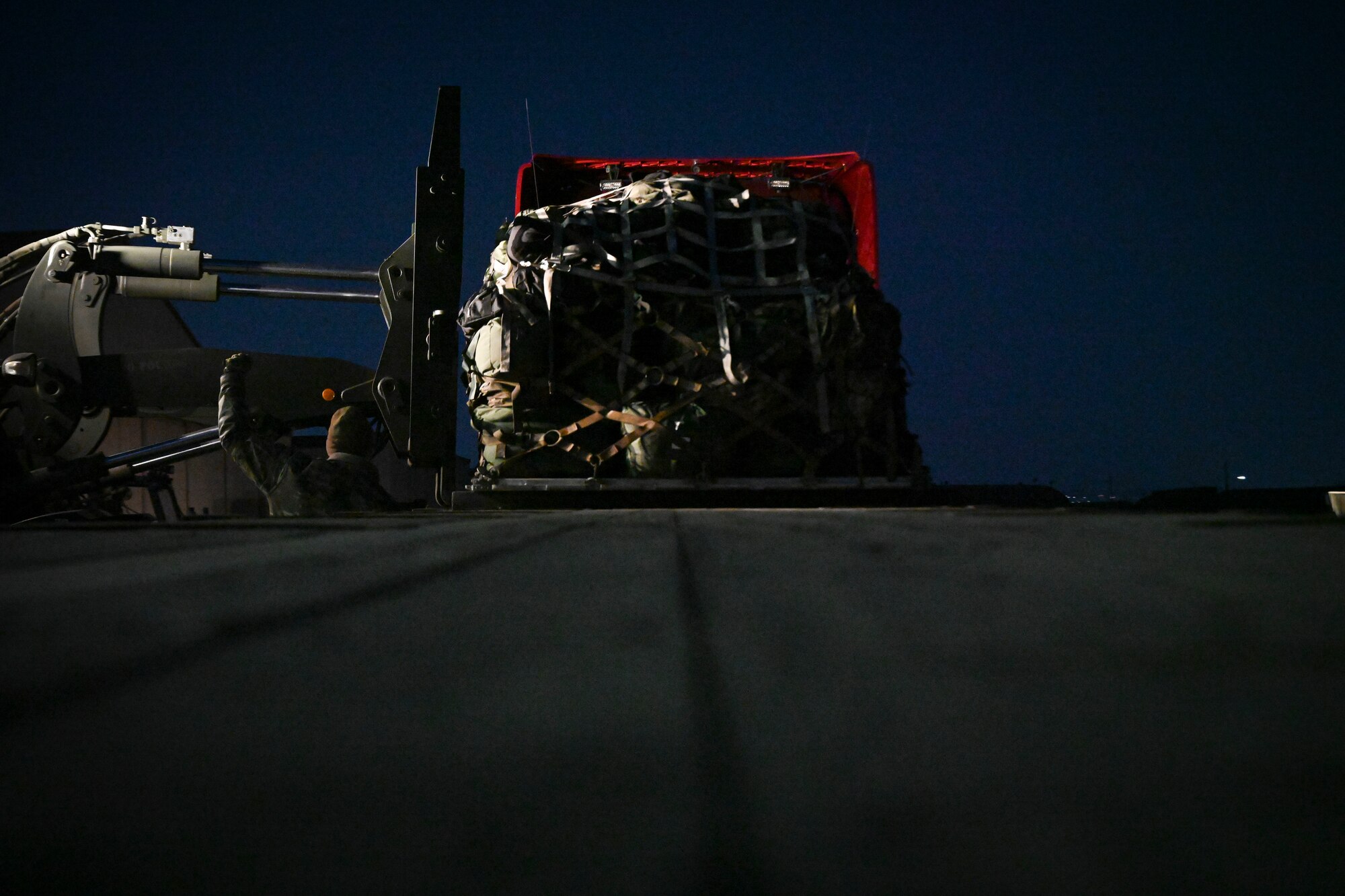 U.S. Air Force Tech. Sgt. William Russell, 8th Maintenance Group maintenance operations center senior controller, directs a forklift to lift cargo from a truck from Kunsan Air Base for Beverly Pack 25-1 at Gwangju Air Base, Republic of Korea, Jan. 12, 2025.