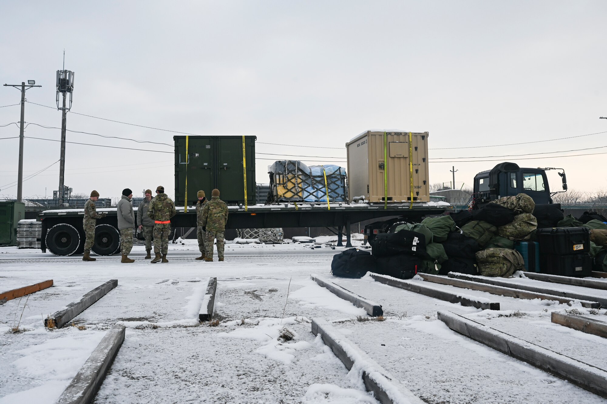 Airmen assigned to the 8th Logistics Readiness Squadron, prepare to unload cargo from a vehicle during a cargo deployment function line during Beverly Pack 25-1.