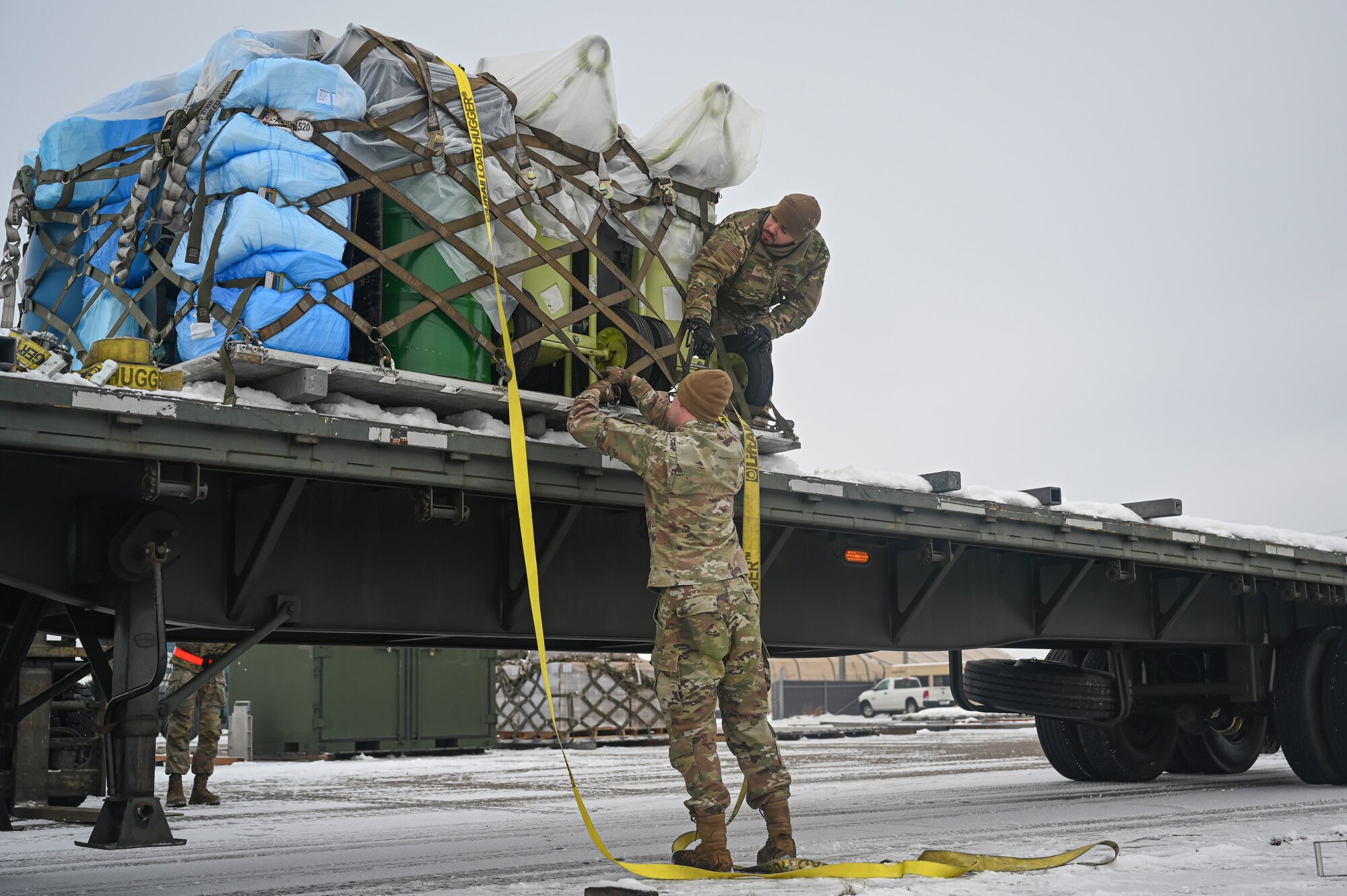 Senior Airman Austin Payton, left, 8th Logistics Readiness Squadron ground transportation journeyman, and U.S. Air Force Staff Sgt. William Rios-Cruz, 8th LRS air transportation function supervisor, unstrap cargo from a vehicle during Beverly Pack 25-1.