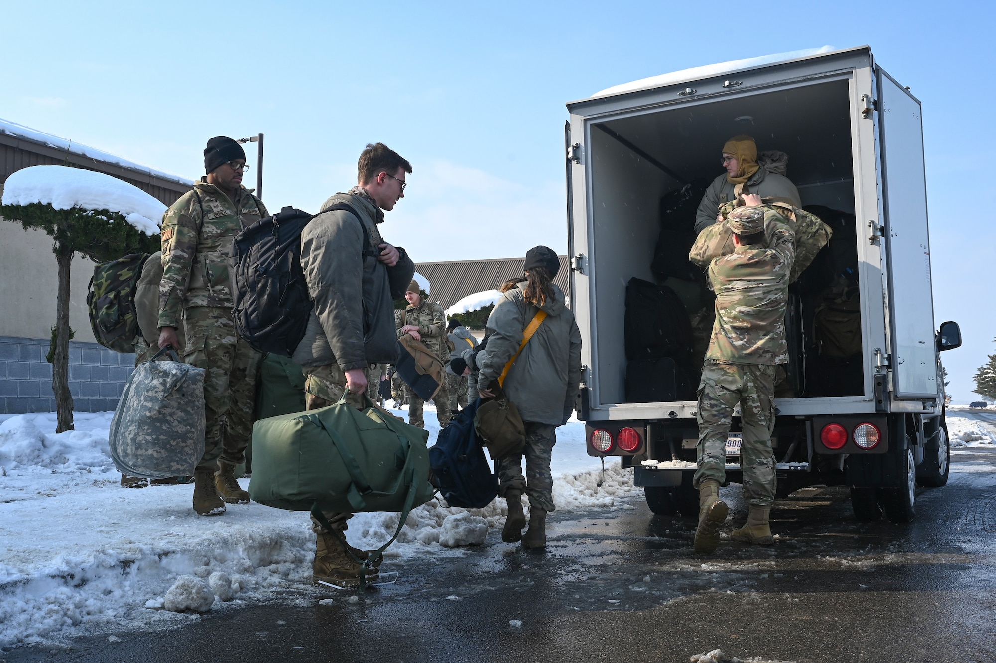 Airmen assigned to the 8th Fighter Wing load baggage into a vehicle during a personnel deployment function line for Beverly Pack 25-1.
