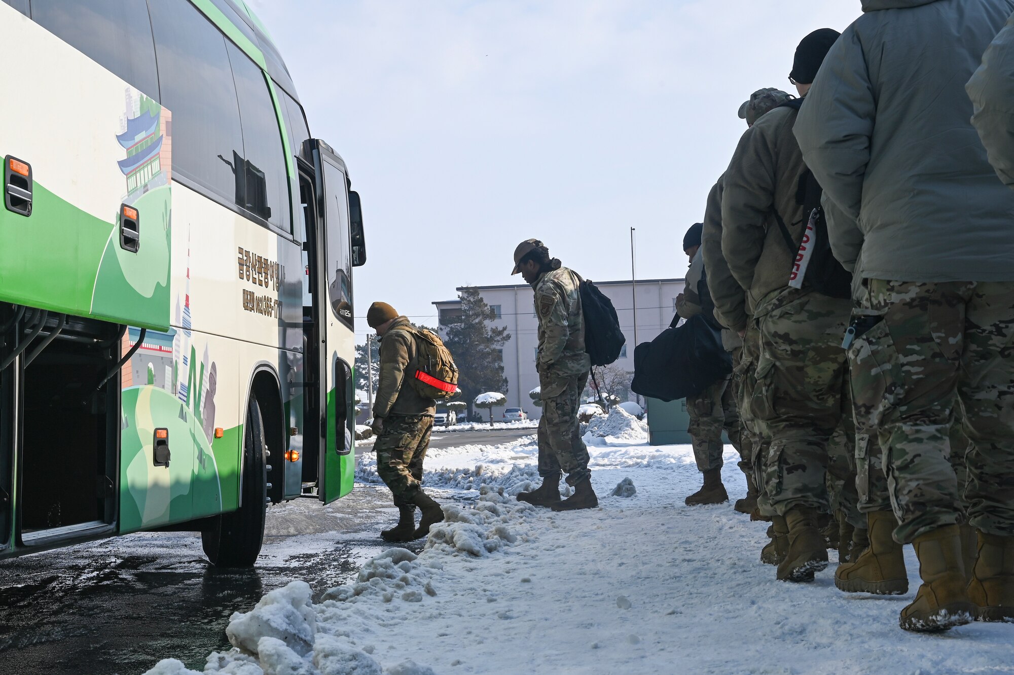 Airmen assigned to the 8th Fighter Wing board a bus after completing a personnel deployment function line during Beverly Pack 25-1.