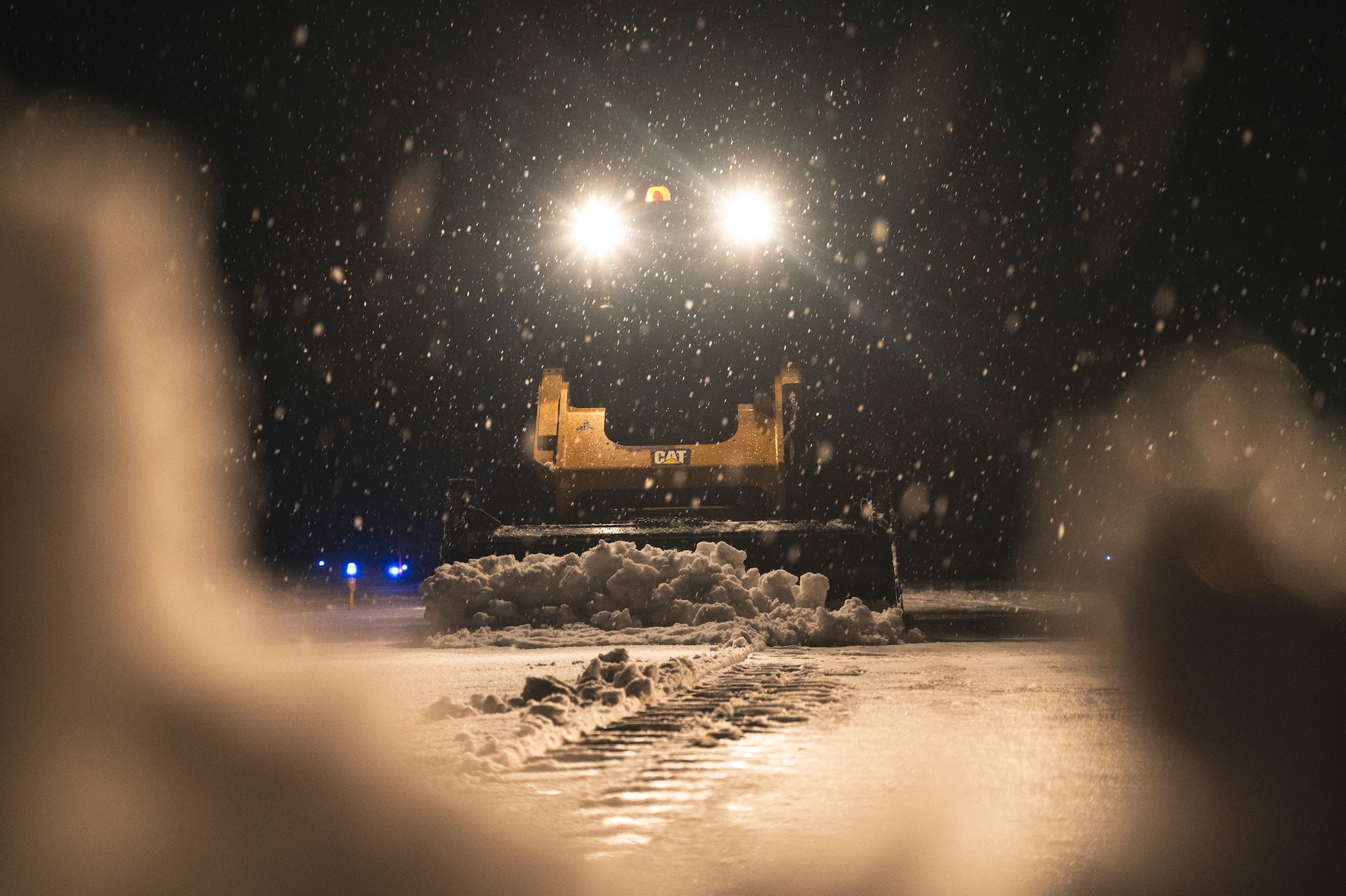 Senior Airman Joseph Parmer, 8th Civil Engineering Squadron pavement and equipment operator, operates a compact track loader to clear the flightline.