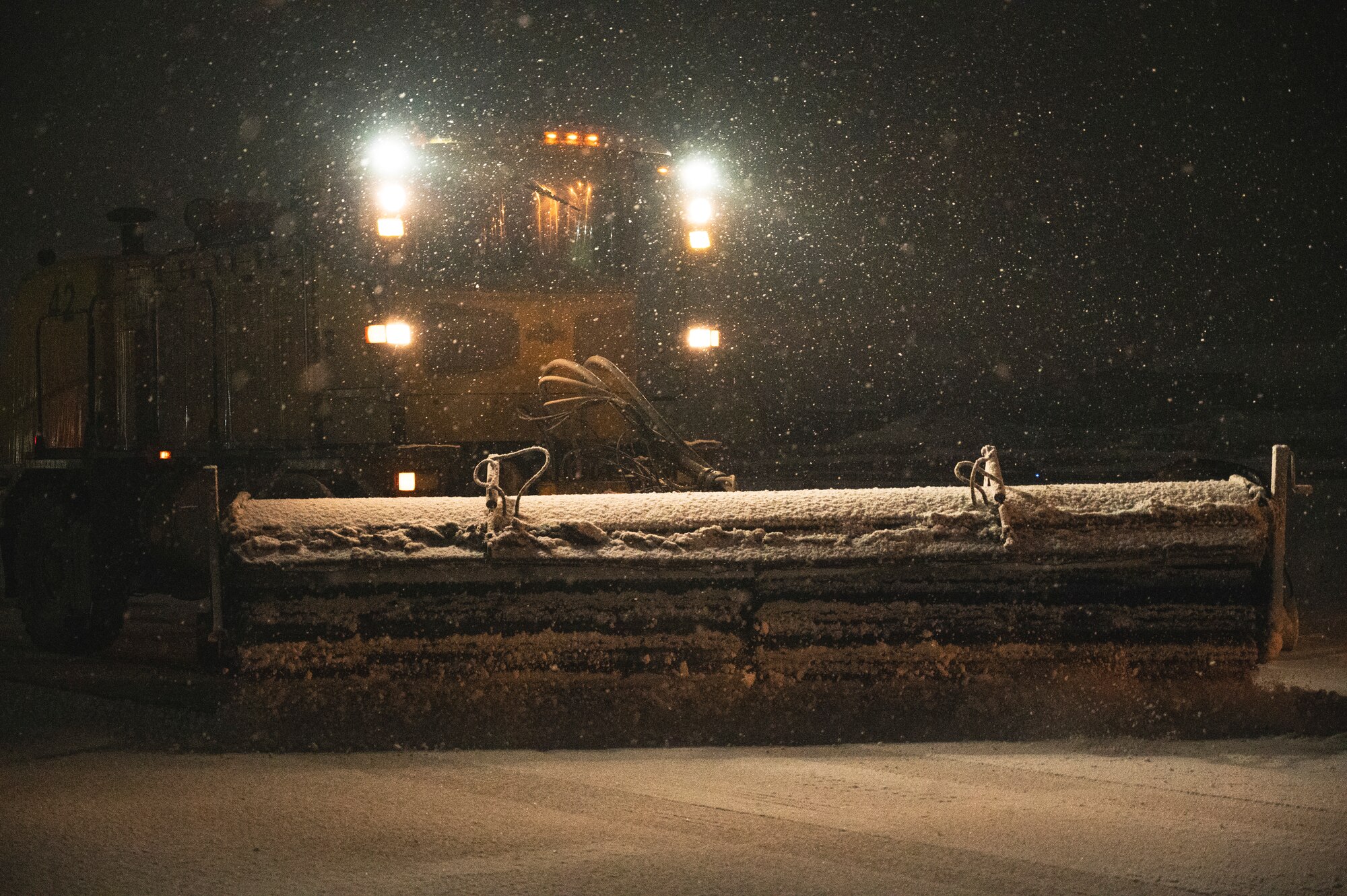 U.S. Air Force Staff Sgt. Adam Backus, 8th Civil Engineering Squadron pavement and equipment operator, utilizes an Oshkosh broom to clear the taxiway on the flightline.