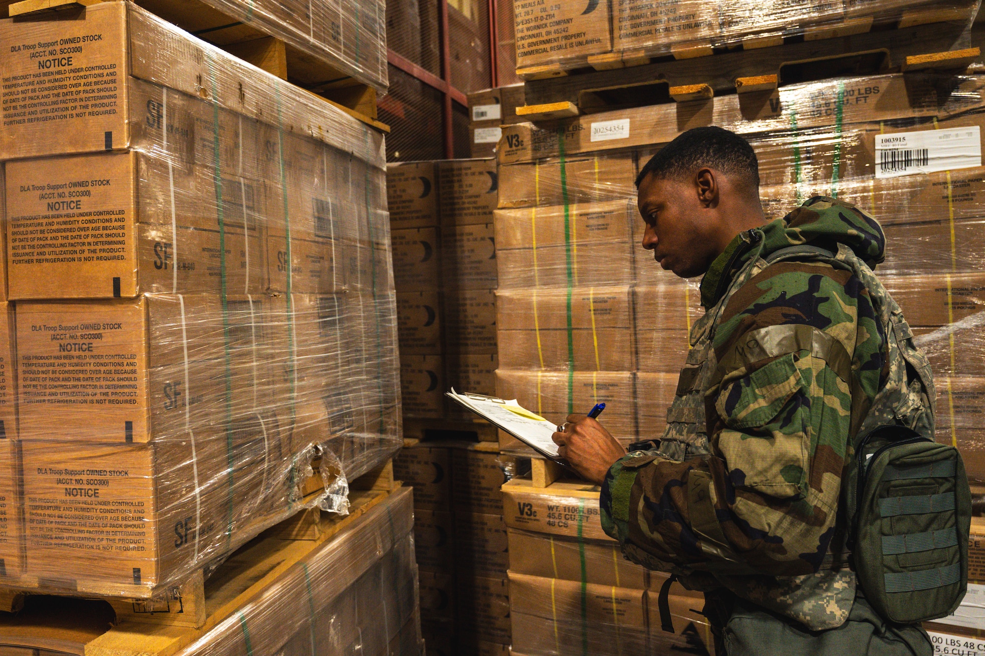 Senior Airman OShane Williams, 8th Operational Medical Readiness Squadron public health technician, inspects meal ready-to-eat pallets for contaminants.